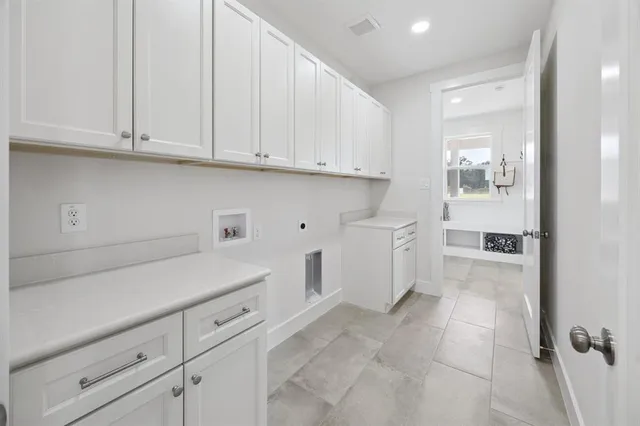 a view of a kitchen with white cabinets