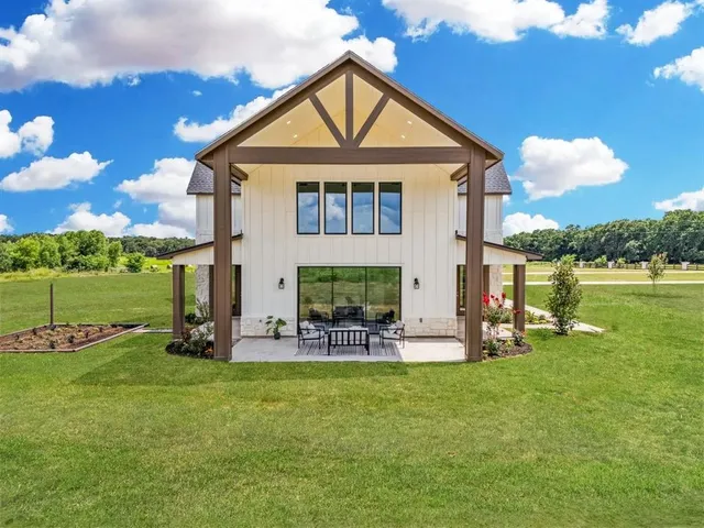 a view of a house with a yard and sitting area