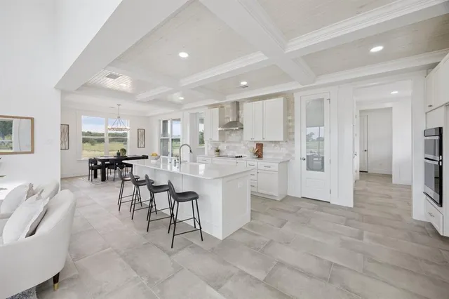 a kitchen with a sink and chairs