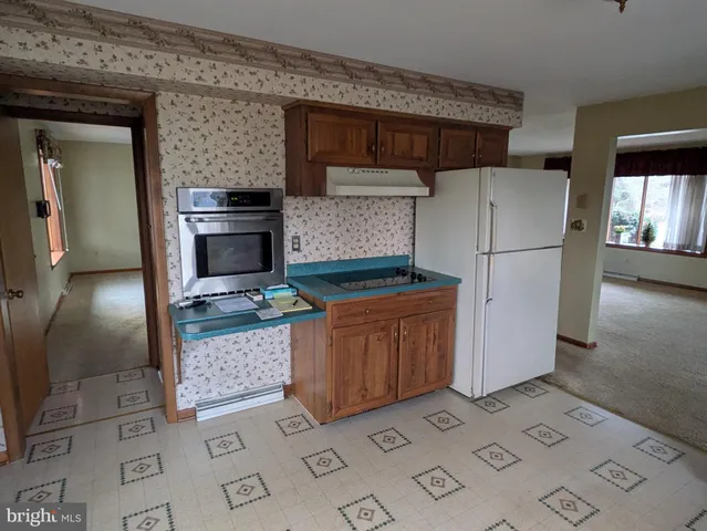 a refrigerator freezer sitting inside of a kitchen