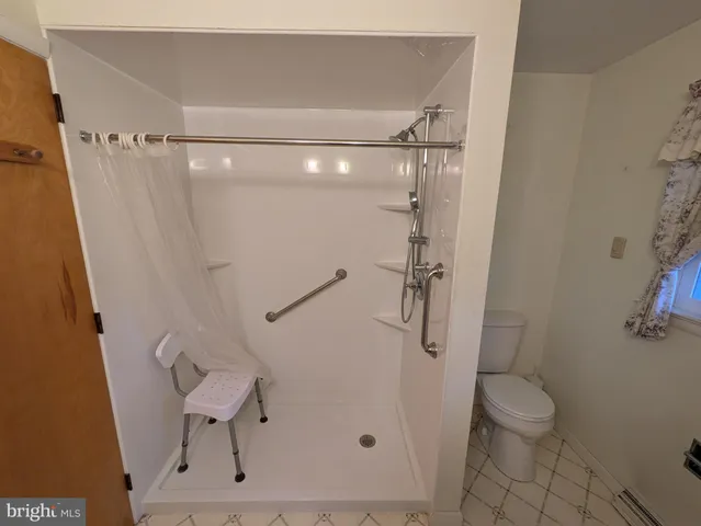 a bathroom that has a toilet and a shower