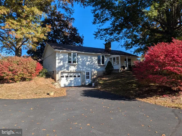 a front view of a house with a yard garage and outdoor seating