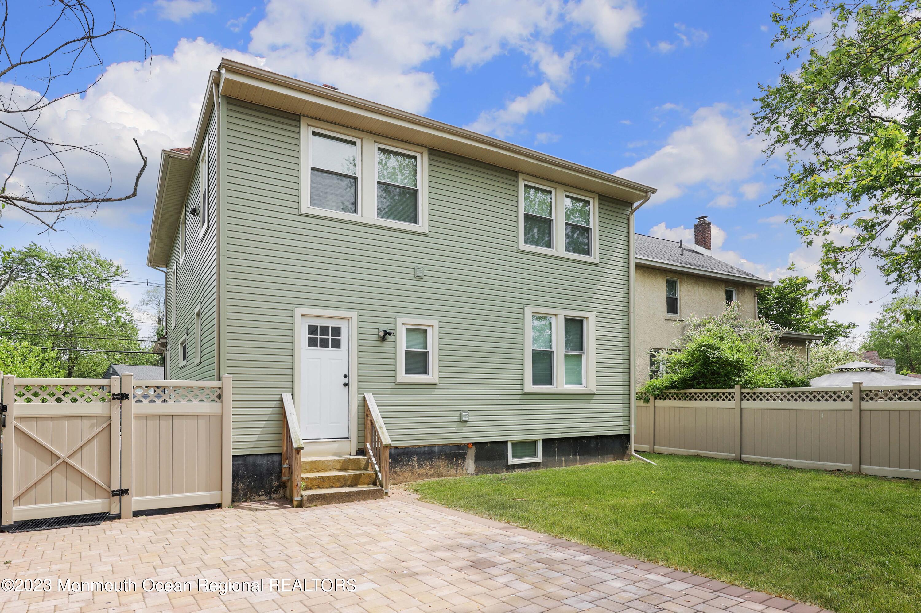 278 Broad Street, Unit FIRST Matawan, NJ 07747 - Photo 22 of 26 a front view of a house with a yard