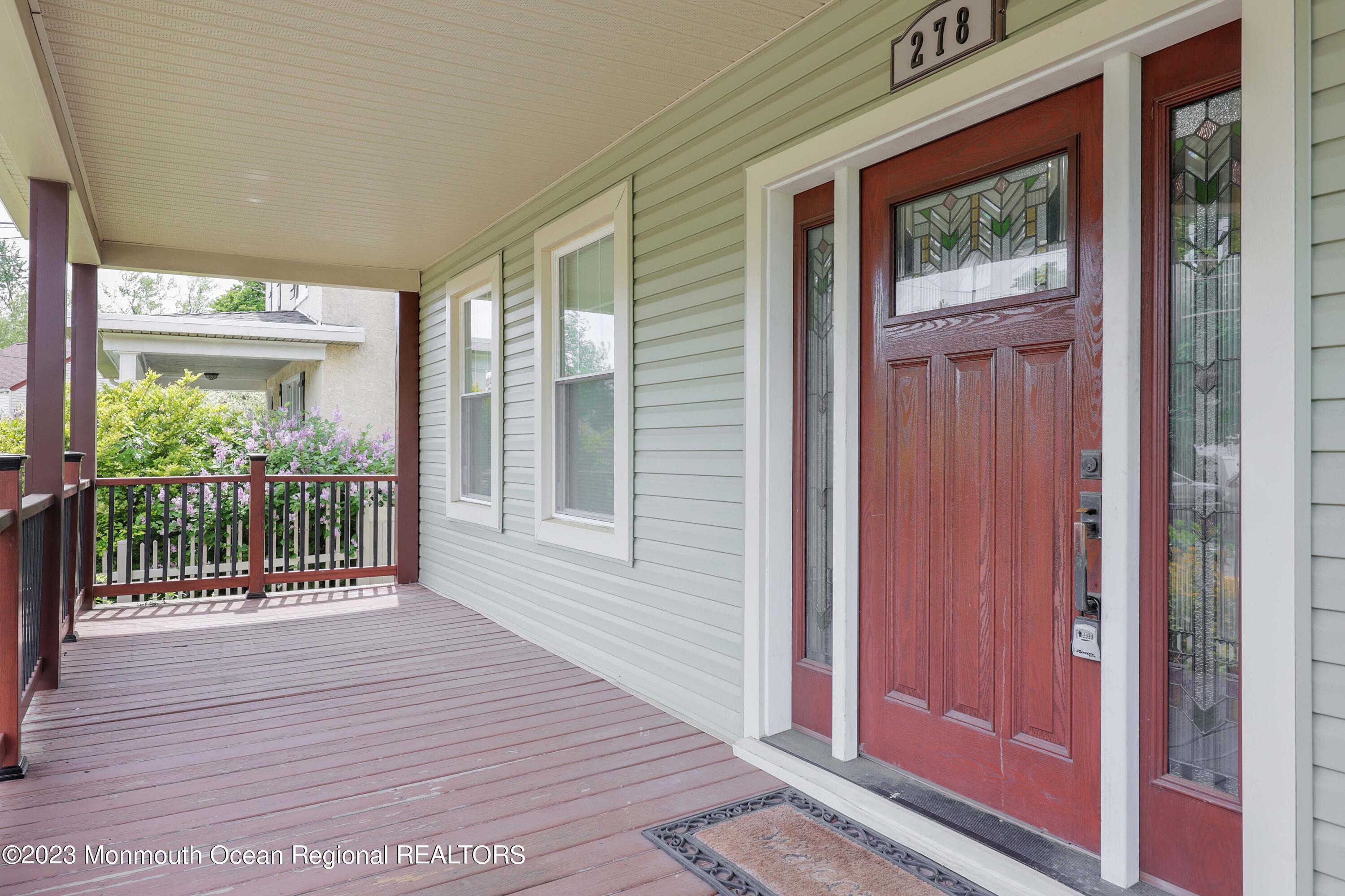 278 Broad Street, Unit FIRST Matawan, NJ 07747 - Photo 3 of 26 a view of a porch with wooden floor and front door