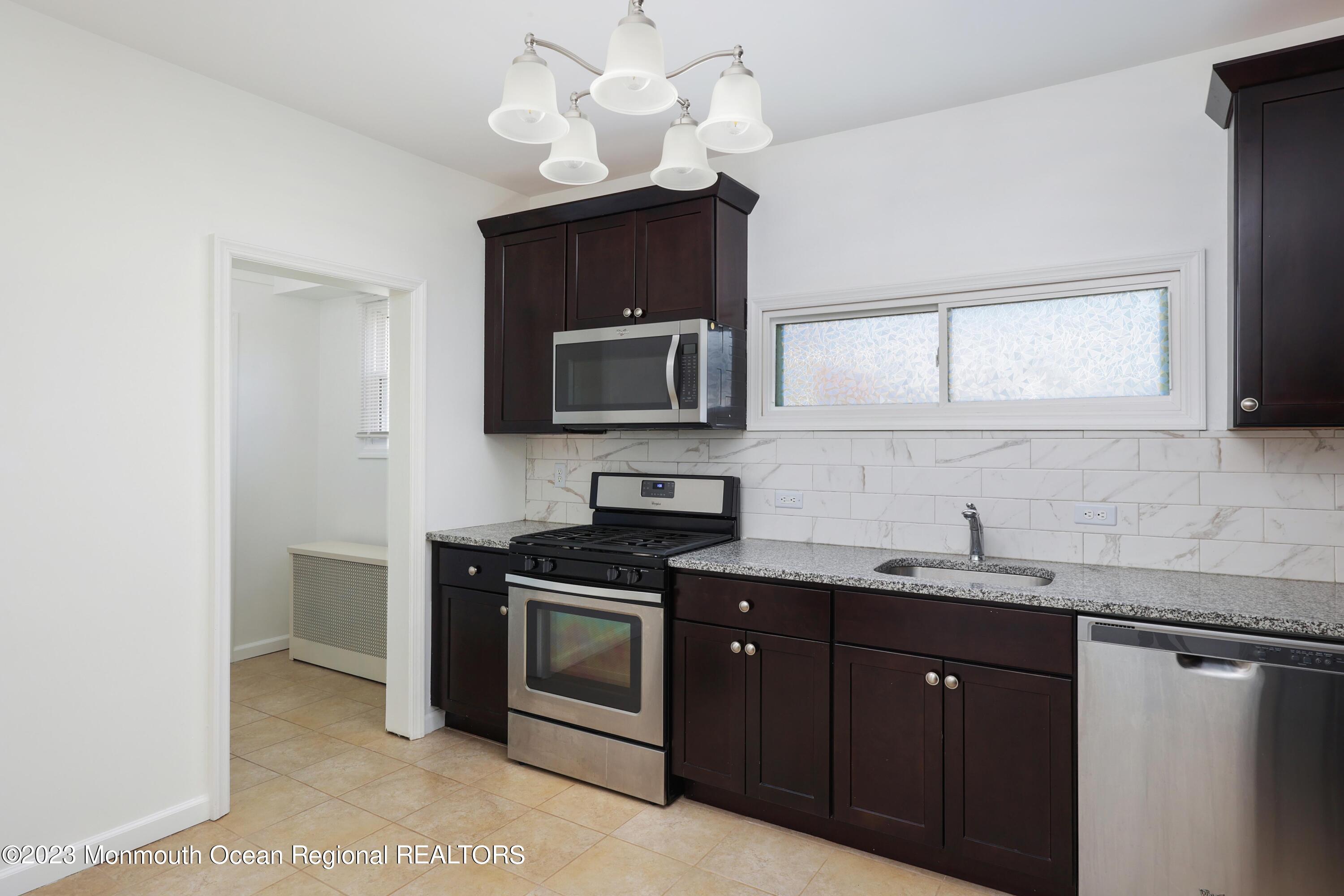 278 Broad Street, Unit FIRST Matawan, NJ 07747 - Photo 6 of 26 a kitchen with a sink and a microwave