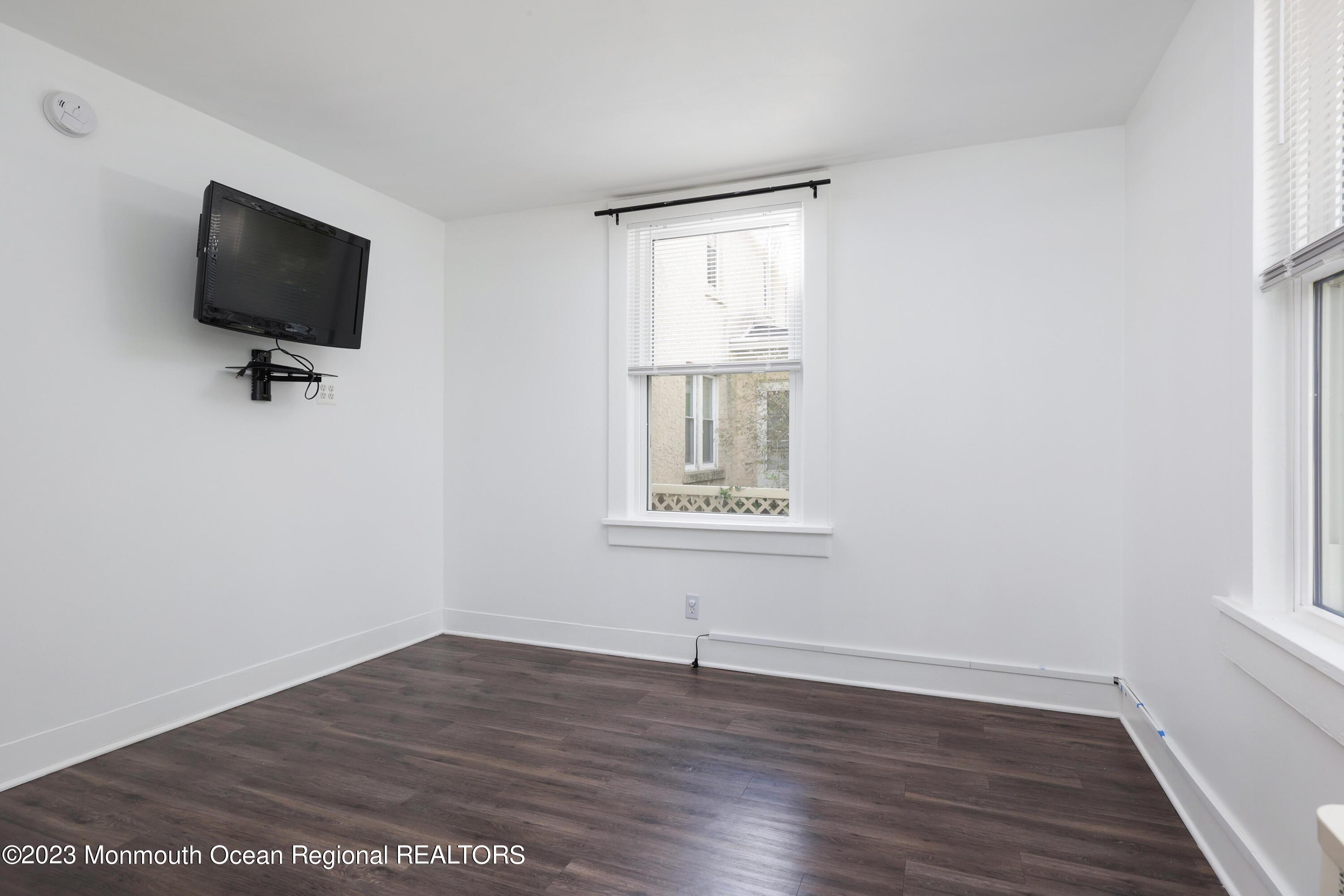 278 Broad Street, Unit FIRST Matawan, NJ 07747 - Photo 9 of 26 a view of room with hardwood floor and window