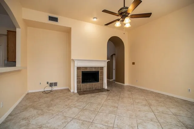 a room with a fireplace and a chandelier