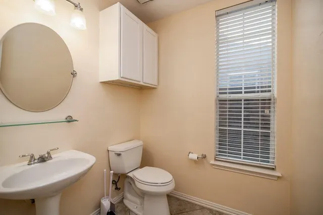 a bathroom with a sink a toilet and mirror
