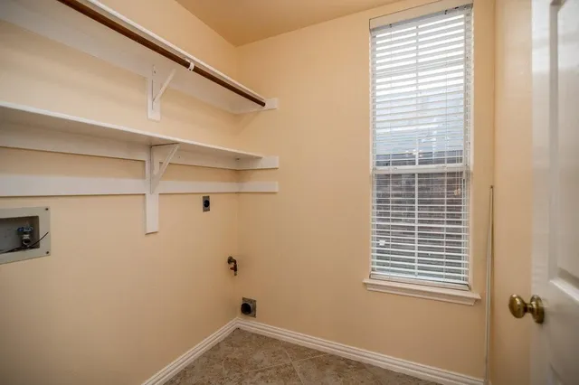 a view of a room with rack on the wall and a window