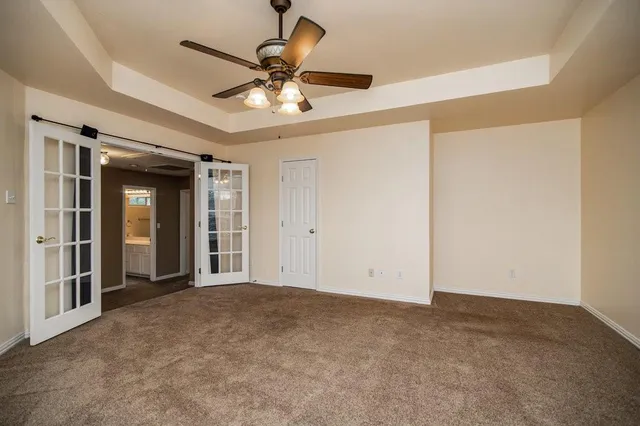 a view of a livingroom with a ceiling fan and window