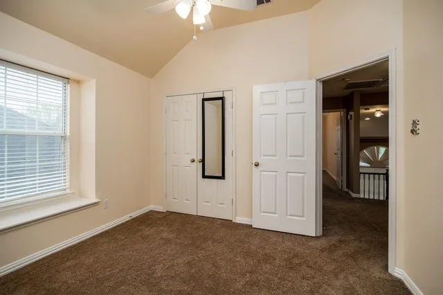 an empty room with windows and closet