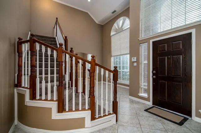 a view of staircase with railing and a window