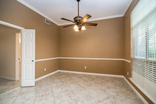 a view of room with window and ceiling fan