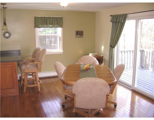 95 Tripps Corner Road Exeter, RI 02822 - Photo 4 of 20 Dining Room. Dining Area has Gleaming Hardwoods and 1 of 3 Sliders leading to a 32 Ft Deck. Windows and Sliders are 5 yr new