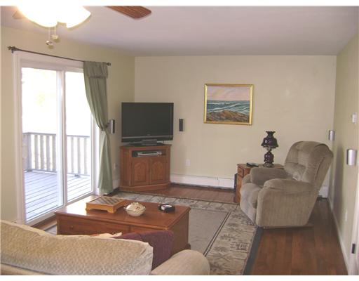 95 Tripps Corner Road Exeter, RI 02822 - Photo 5 of 20 Living Room. Living Room has Gleaming Hardwoods and 1 of 3 Sliders leading to a 32 Ft Deck