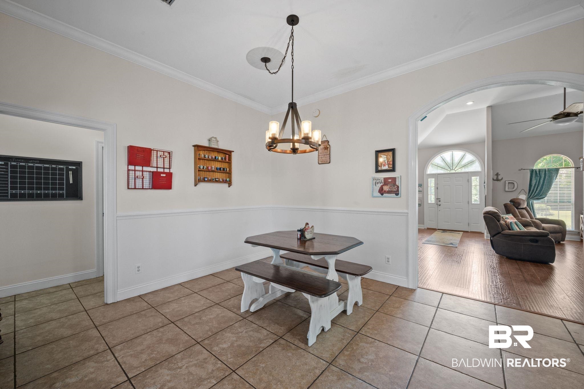 48513 Phillipsville Road Bay Minette, AL 36507 - Photo 12 of 50 Tiled dining space with arched walkways, crown molding, a chandelier, and a ceiling fan