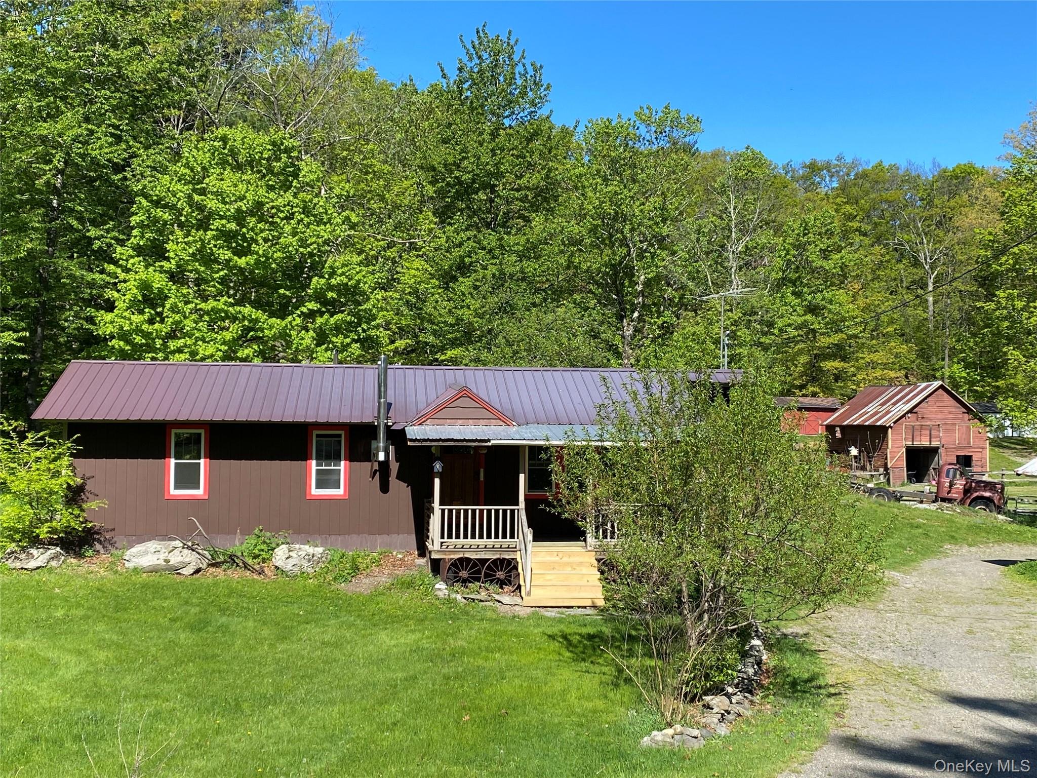 74 Lamoree Road Rhinebeck, NY 12572 - Photo 1 of 22 a front view of a house with a garden