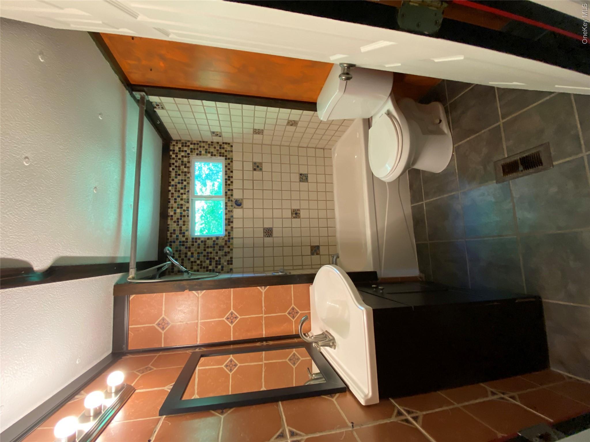 74 Lamoree Road Rhinebeck, NY 12572 - Photo 12 of 22 a bathroom with a sink toilet and shower