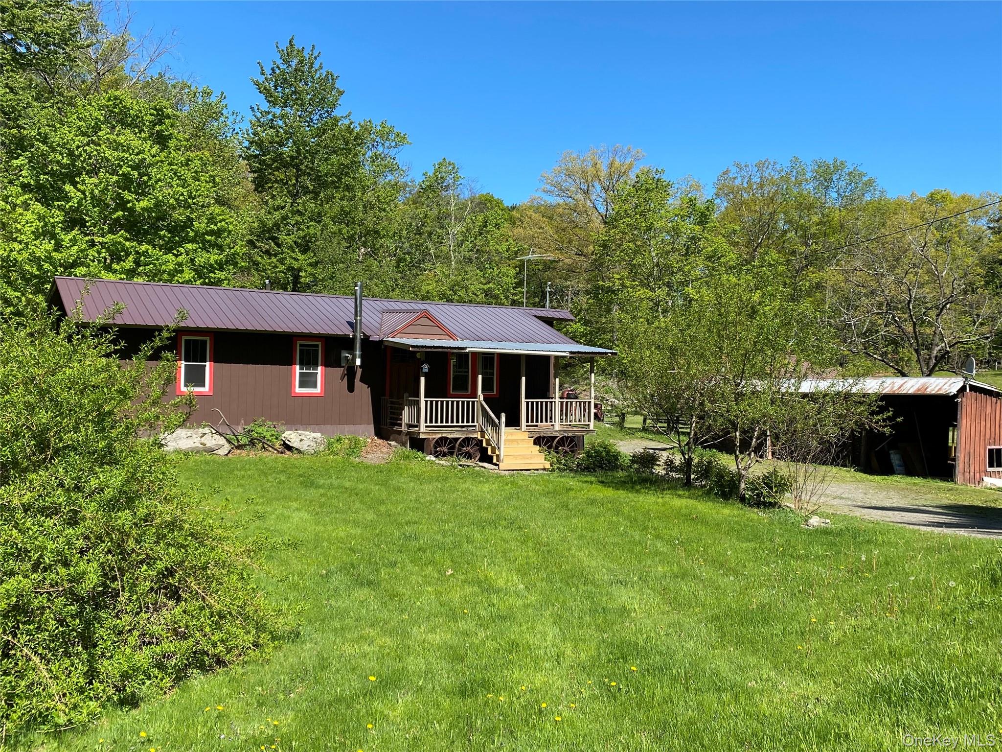 74 Lamoree Road Rhinebeck, NY 12572 - Photo 2 of 22 a view of a house with a yard