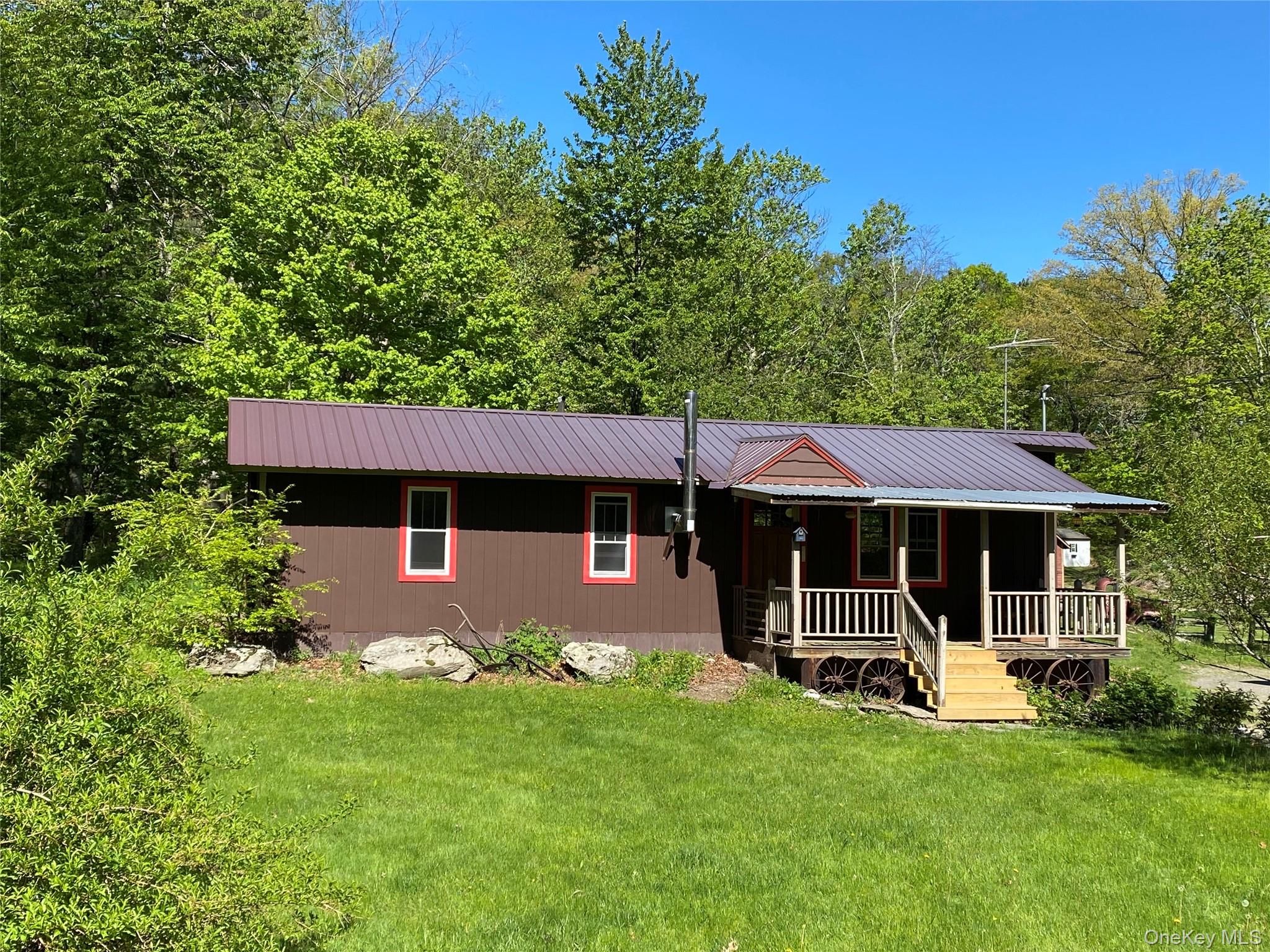 74 Lamoree Road Rhinebeck, NY 12572 - Photo 4 of 22 a view of a house with a backyard garden and sitting area