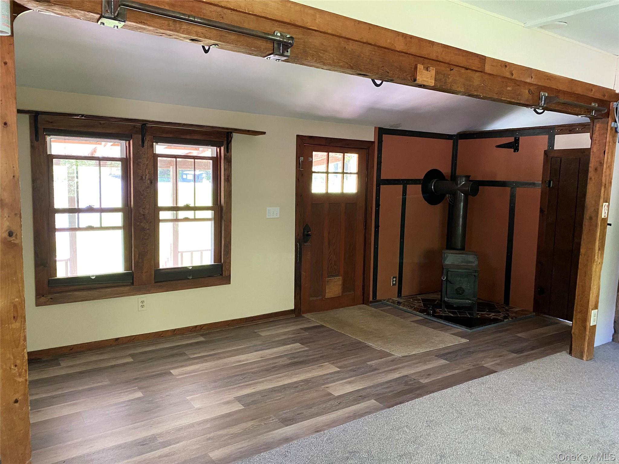 74 Lamoree Road Rhinebeck, NY 12572 - Photo 7 of 22 a view of a room that has a large window and a wooden floor