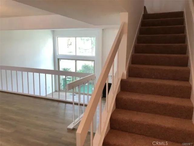 a view of wooden floor and a window in a room