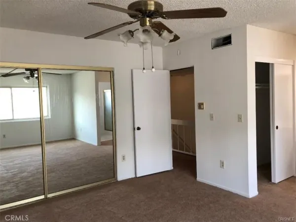 a view of wooden floor and a window in a room
