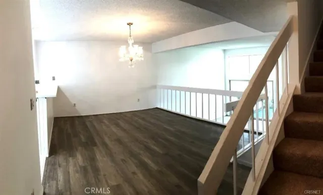 a kitchen with stainless steel appliances a refrigerator a stove a microwave and white cabinets