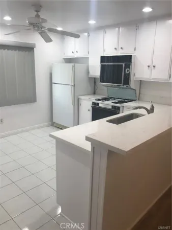 a kitchen with a sink and a stove top oven