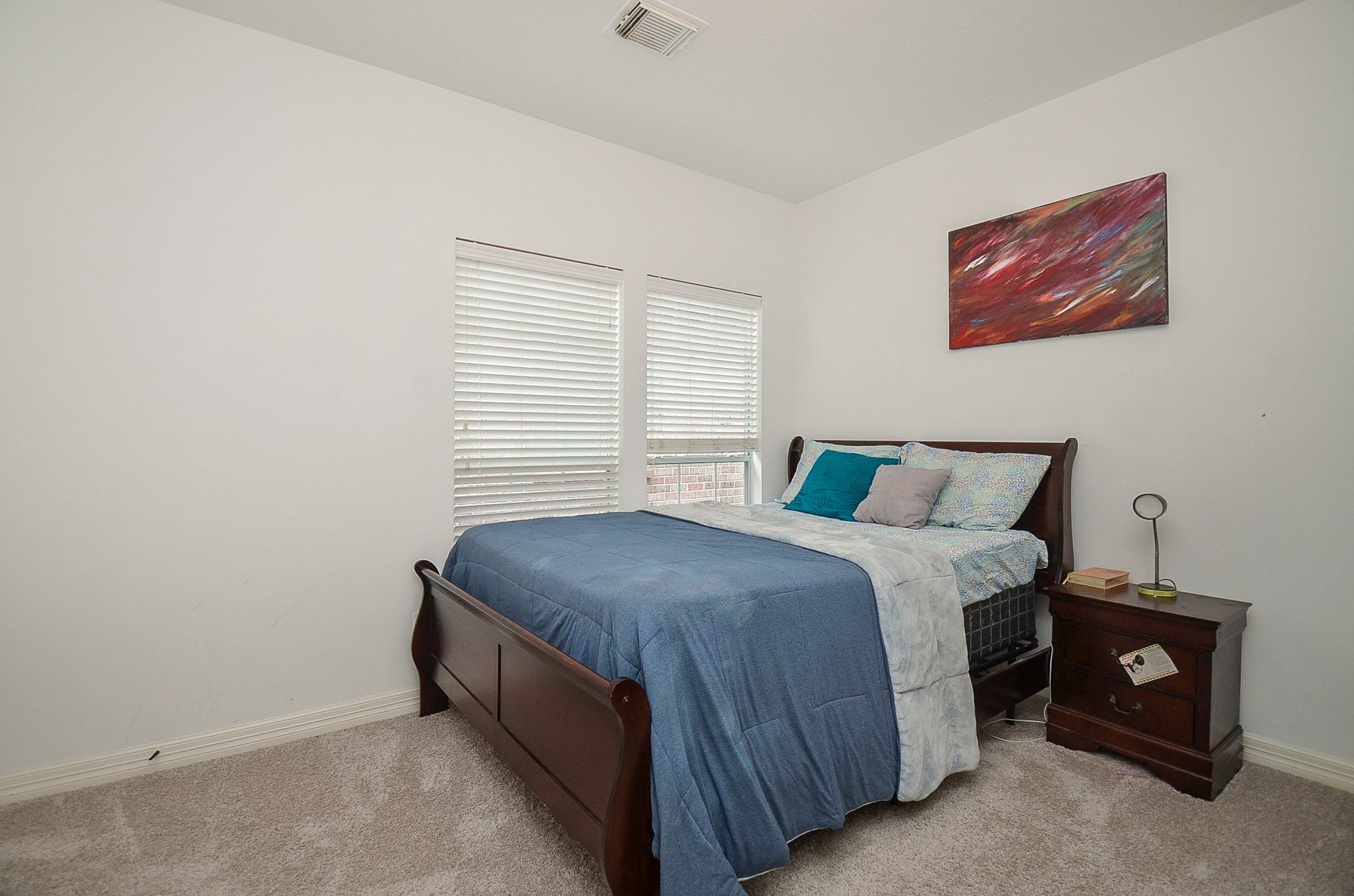 13511 Brookbluff Lane Houston, TX 77077 - Photo 14 of 16 a bedroom with a bed and a window