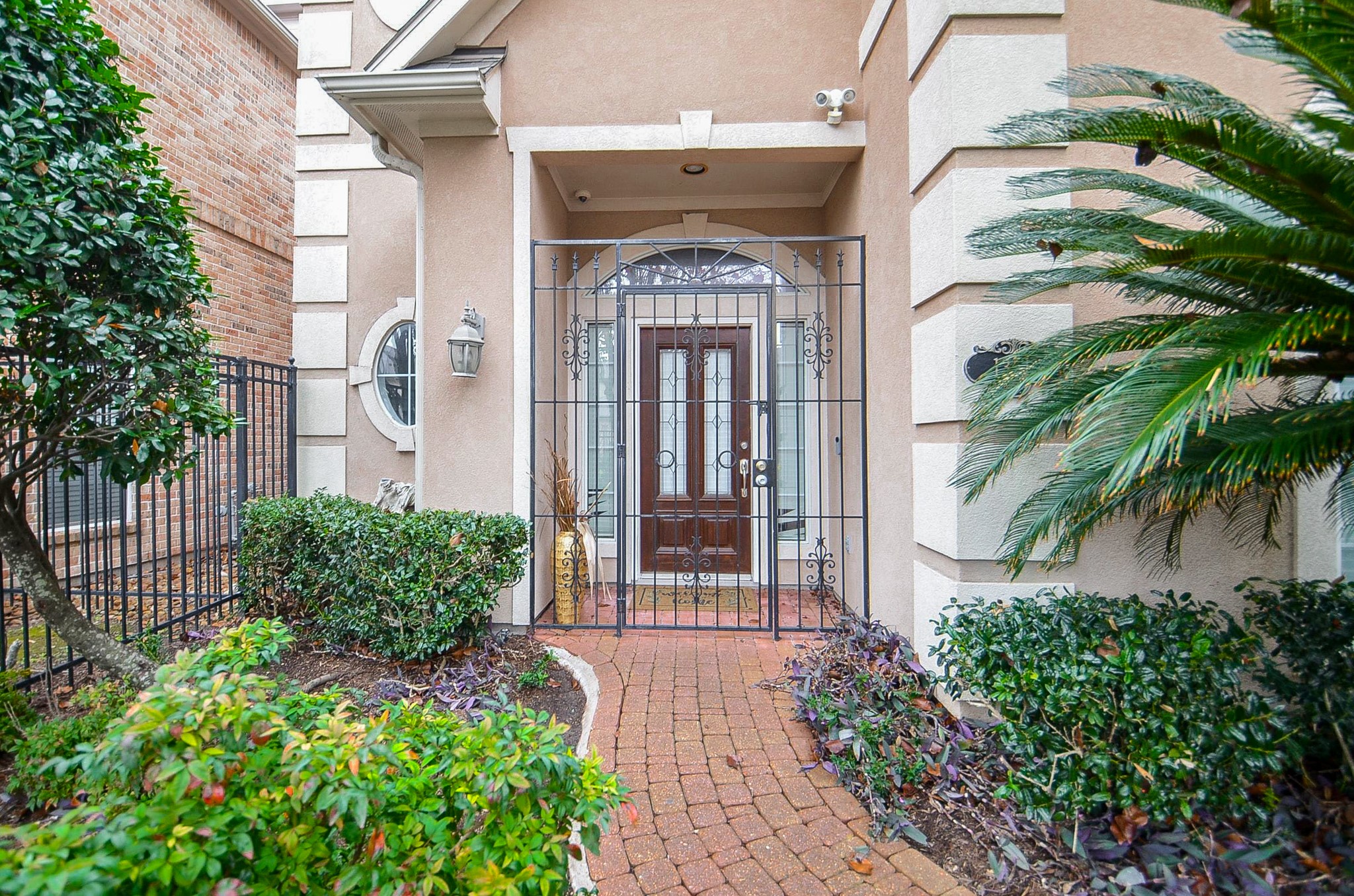 13511 Brookbluff Lane Houston, TX 77077 - Photo 3 of 16 a front view of a house with garden