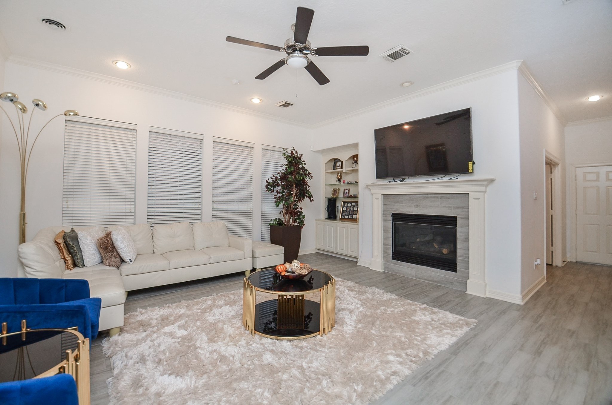 13511 Brookbluff Lane Houston, TX 77077 - Photo 6 of 16 a living room with furniture a flat screen tv and a fireplace