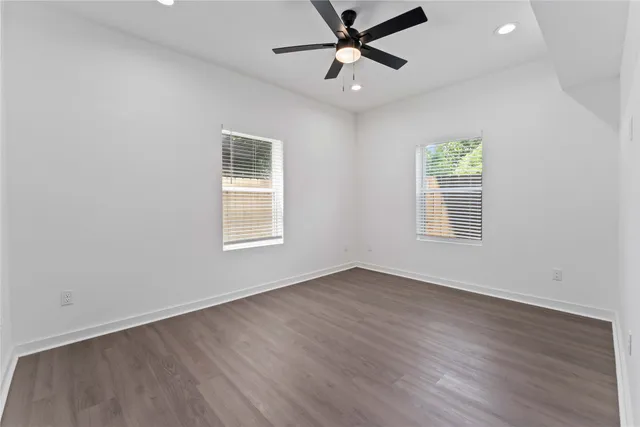 wooden floor in an empty room with a window
