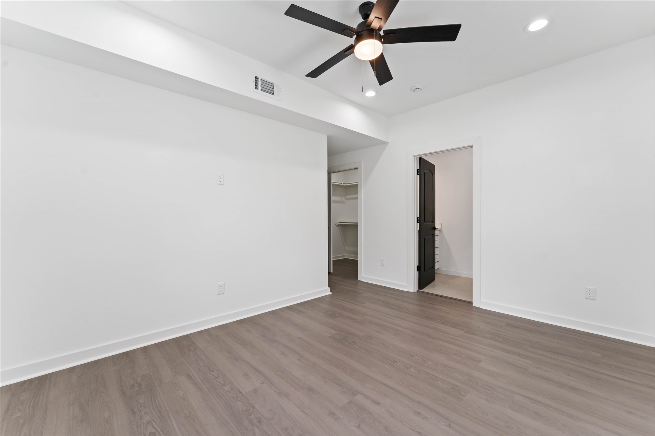 414 North Carolina Street, Unit A Houston, TX 77029 - Photo 21 of 25 an empty room with wooden floor and a ceiling fan