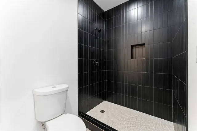 a bathroom with a toilet and a shower