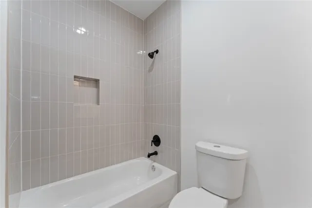 a bathroom with a bathtub and toilet