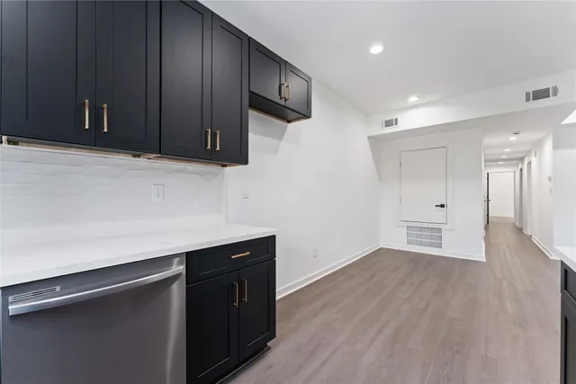 a kitchen with a sink and cabinets