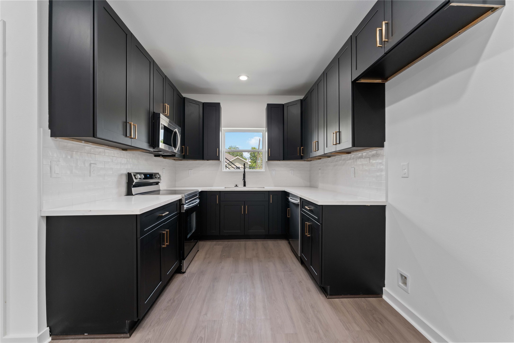 414 North Carolina Street, Unit A Houston, TX 77029 - Photo 8 of 25 a kitchen with stainless steel appliances granite countertop a sink stove and refrigerator