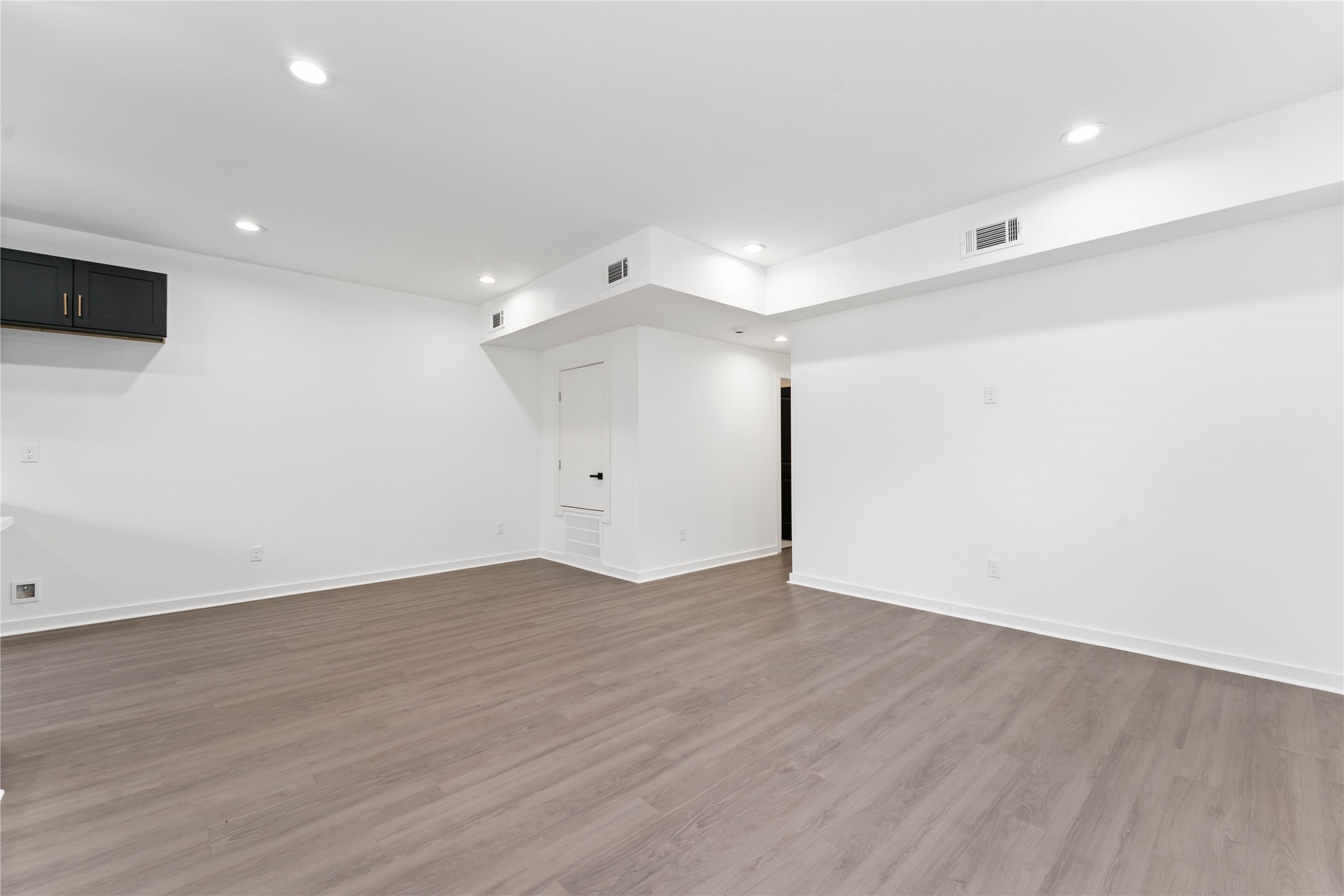 414 North Carolina Street, Unit A Houston, TX 77029 - Photo 9 of 25 an empty room with wooden floor and windows