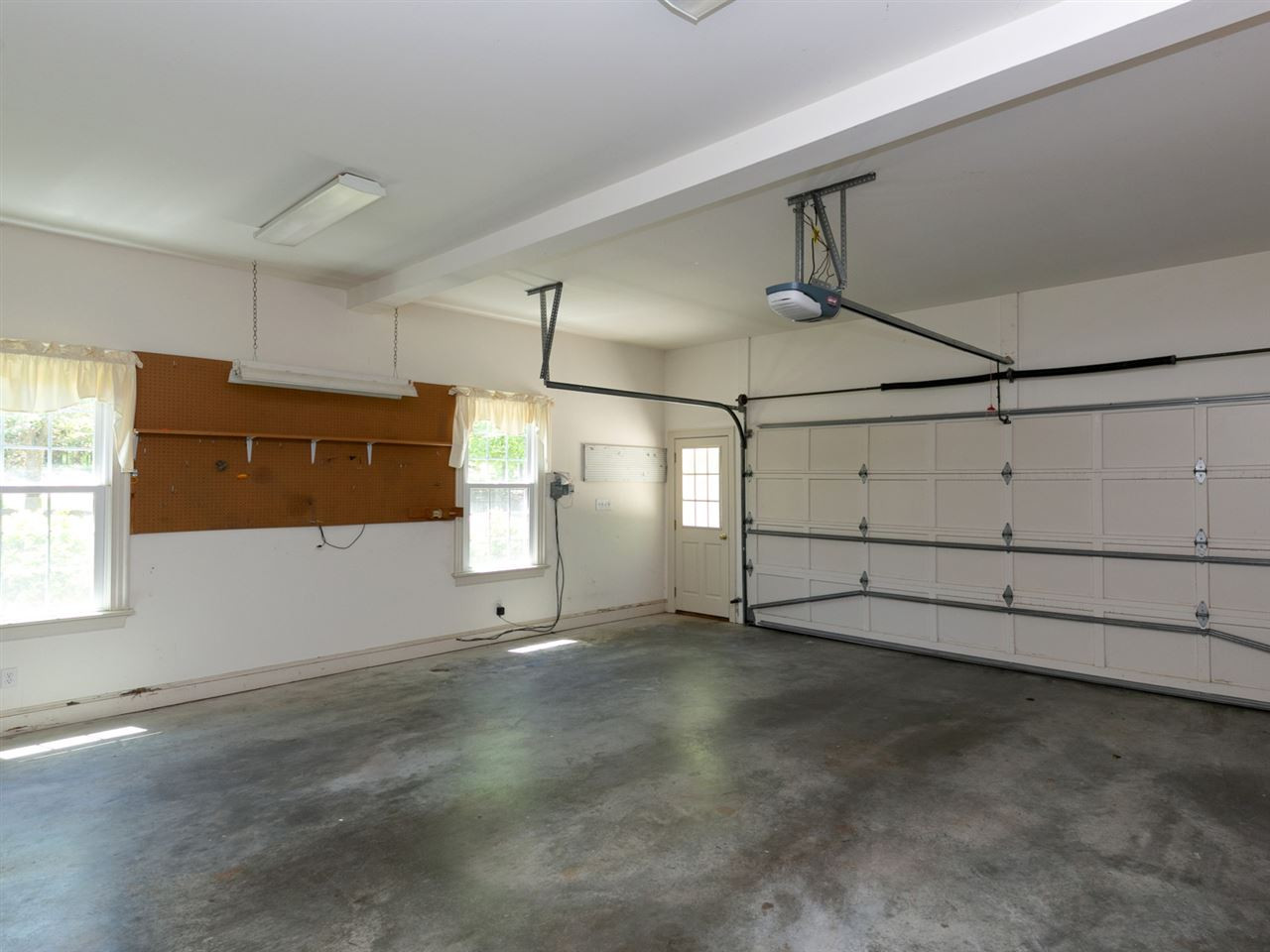 1609 Adams Mountain Road Raleigh, NC 27614 - Photo 24 of 29 The over-sized main level garage has room for two cars, shelving for storage and direct access to the home. An extended driveway with turnabout leads to this garage. Main Level Garage
