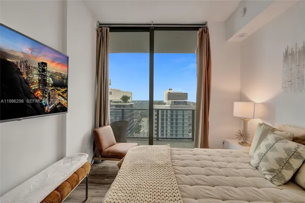 a bedroom with a bed and a night stand