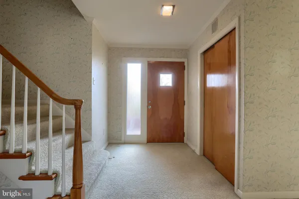 an empty room with windows and fireplace