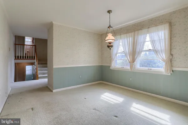 an empty room with windows and entrance