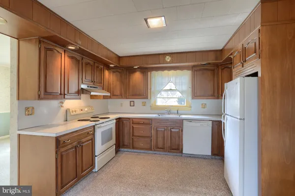 a kitchen with stainless steel appliances a stove and a refrigerator