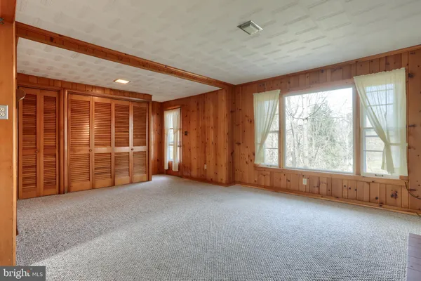 a view of empty room with a fireplace and window