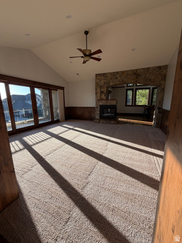 4536 North 475 East Provo, UT 84604 - Photo 13 of 65 Spacious living area featuring vaulted ceilings, a stone-faced fireplace, a ceiling fan, and recessed lighting