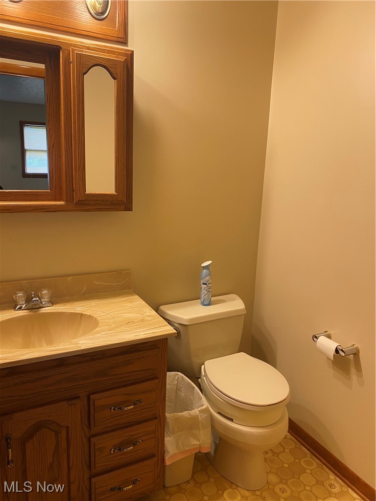 36889 Capel Road Grafton, OH 44044 - Photo 14 of 26 Half bathroom with vanity, toilet, and baseboards