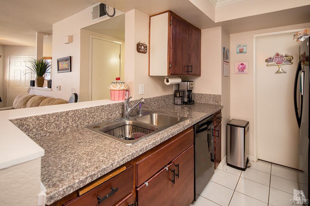 1175 Fitzgerald Road, Unit A Simi Valley, CA 93065 - Photo 6 of 16 a kitchen with stainless steel appliances granite countertop a sink stove and refrigerator