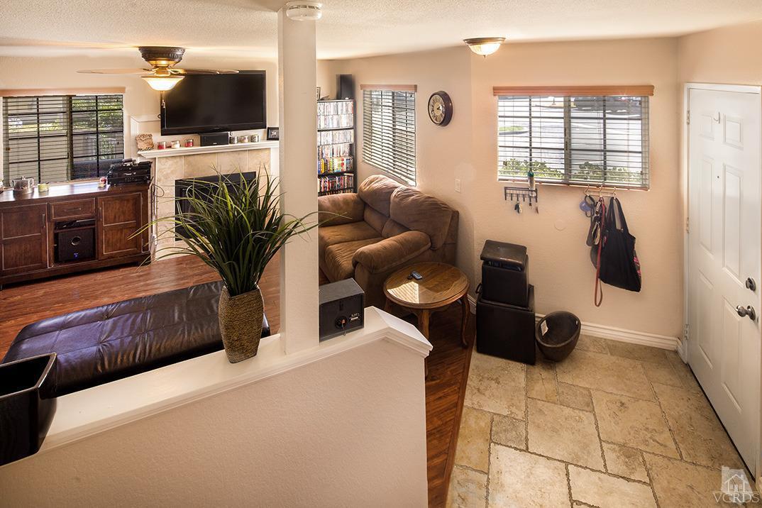 1175 Fitzgerald Road, Unit A Simi Valley, CA 93065 - Photo 8 of 16 a living room with furniture and a flat screen tv
