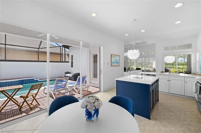a kitchen with stainless steel appliances kitchen island granite countertop a sink and cabinets